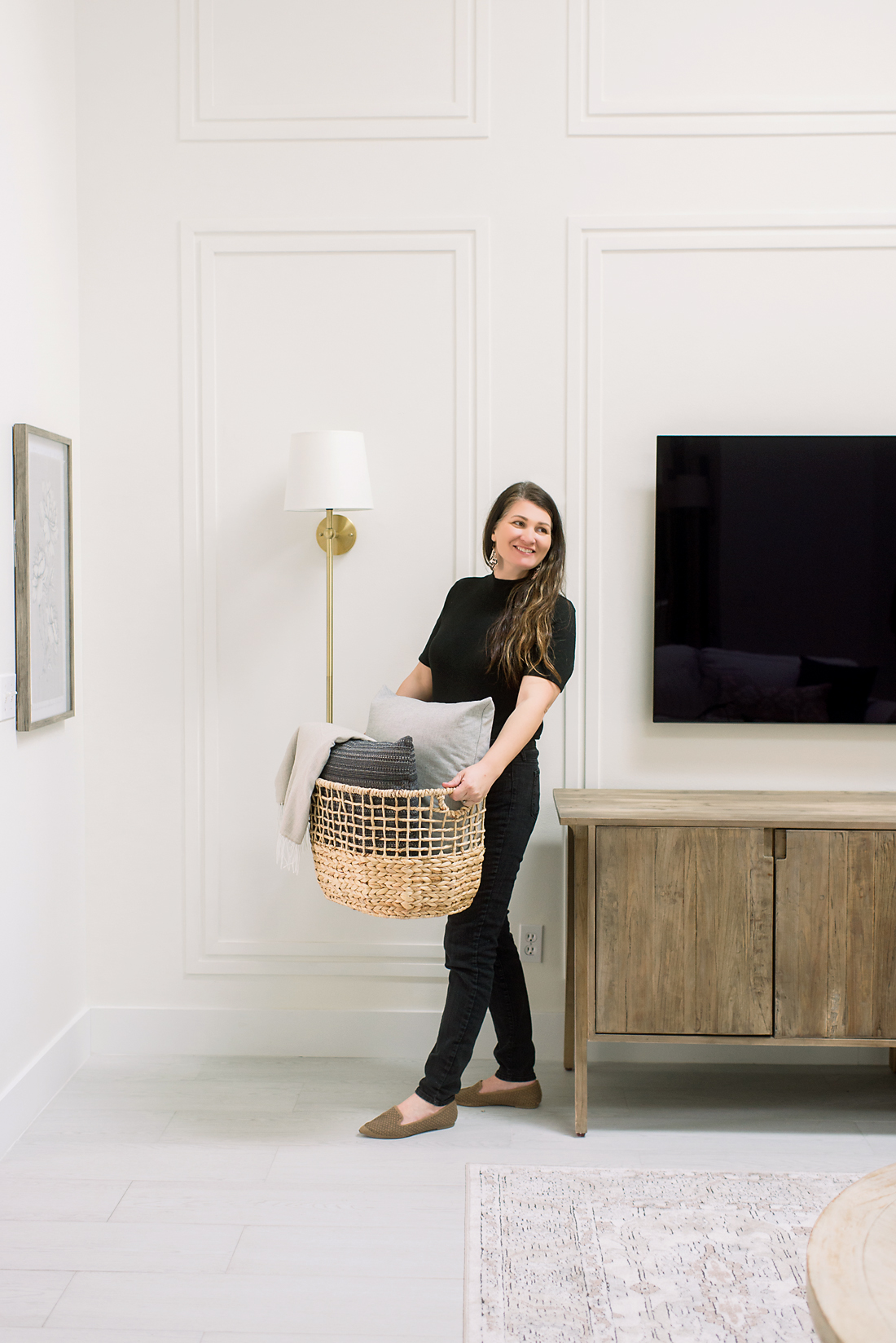 Interiro Designer holding an accessory basket to place in client's home